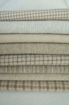 a stack of different types of fabric on top of each other in various colors and patterns