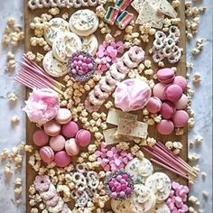 a tray filled with lots of different types of sweets on top of a table next to candy