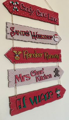 wooden signs are hanging on the wall for christmas decorations and gifts to give as presents