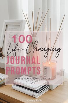 a table with candles and books on it that says, 100 life - changing journal prompts