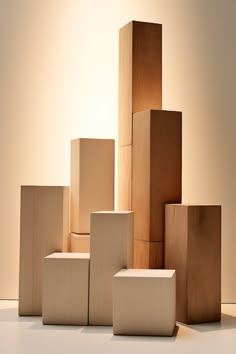 several wooden blocks stacked on top of each other in front of a white wall and floor