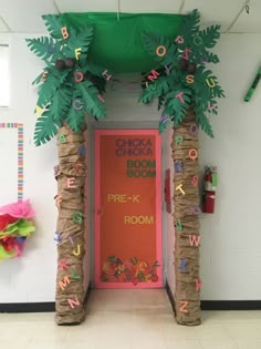 a classroom door decorated with paper mache and palm trees that spell out the word'chicka chicka boom '