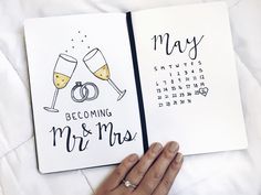 someone is holding up a wedding planner with two champagne glasses on it and the date may