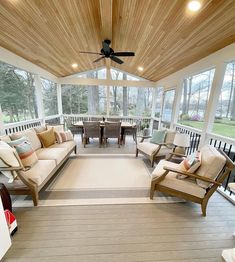 a covered porch with couches and chairs on it