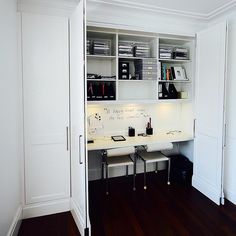 an office with white walls and wooden floors