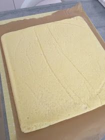 a square cake sitting on top of a piece of cardboard