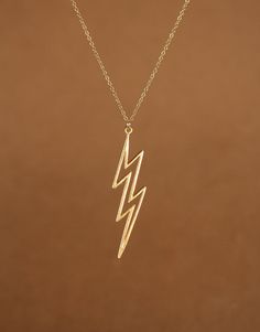 Lightning bolt necklace, gold thunder bolt pendant, layering necklace, a 14k gold vermeil lightening bolt on a 14k gold filled chain This awesome 14k gold plated sterling silver lightening bolt hangs from a 14k gold filled chain in the length of your choice! This beauty is also available in sterling silver! Bolt Measurements: 38mm x 10mm Looking for other charm necklaces? https://www.etsy.com/shop/BubuRuby?section_id=12318467 More from Bubu Ruby? https://www.etsy.com/shop/BubuRuby?ref=si_shop ♥ Thunder Bolt, Lightning Bolt Necklace, Punk Jewelry, Necklace Layering, Gold Overlay, Gold Necklace Layered, Layering Necklace, Lightning Bolt, Chains For Men