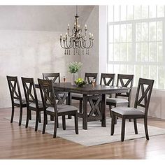 a dining room table with six chairs and a chandelier