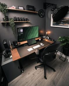 a desk with a computer monitor, keyboard and mouse on it in a dark room