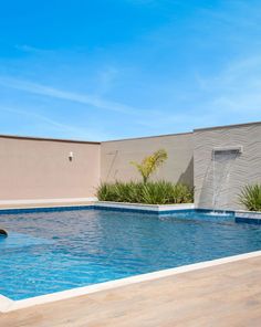 an empty swimming pool in the middle of a patio with water coming out of it