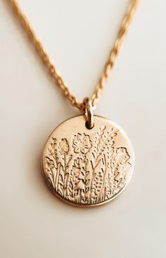 "Coteau des Prairie ✨ Inspired by the beautiful and serene South Dakota prairie.  The drawing is complete with all grasses and wildflowers native to South Dakota such as the state Pasque flower.  The design is my original drawing that was turned into a custom steel stamp that I am able to stamp into your gold filled pendant.  Handmade with 18k gold filled metal pendant and chain.  Choose from two sizes: *Medium (1/2\") Pendant on Simple Chain *Large (3/4\") Pendant on Simple Chain or on a paperclip chain and front toggle clasp Each piece is handstamped so please allow for slight variation as no two pieces are ever exactly alike - that's the beauty of handmade!  Hypo allergenic, lead free, nickel free.  Each necklace comes on a fully adjustable gold filled chain up to 18\" - if you need a l Metal Stamped Necklace, Pasque Flower, Stamped Necklaces, Steel Stamp, Simple Chain, Wheat Field, Summer 24, Metal Pendant, Matching Bracelets