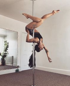 a woman is doing aerial acrobatics on a pole