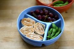 two bowls filled with food sitting on top of a wooden table