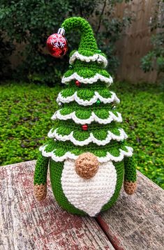 a crocheted christmas tree sitting on top of a wooden table