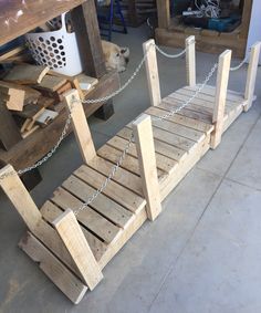 two wooden benches made out of pallets with chains attached to them