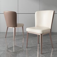 two chairs sitting next to each other in front of a wall