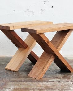 a wooden bench sitting on top of a cement floor