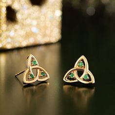 14k Gold and Emeralds Triquetra Stud Earrings | Trinity Knot Post Earrings Also known as the Celtic Trinity Knot, variations of the Triquetra symbol has also appeared on Norse runestones. Material: 14k Gold and Real Emeralds. Handmade and hallmarked in Dublin Castle.Approx. Size: 0.55" (14mm) wide. Worldwide shipping available!Custom order. Please allow about 3-5 business days before item ships.Share on social media: The Triquetra, Triquetra Symbol, Celtic Knot Earrings, Dublin Castle, Celtic Trinity Knot, Emerald Earrings Studs, Knot Stud Earrings, Knot Studs, Trinity Knot