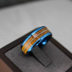 8MM BLUE TUNGSTEN BAND WITH WHISKEY BARREL WOOD AND GUITAR STRING INLAY Need a custom size / design? contact us and we'll make it for you. Please get professionally measured for ring size and read our exchange policy carefully prior to ordering. Wedding Band Music, Guitar String Ring, Guitar Ring, String Ring, Music Rings, Guitar Jewelry, Wood Wedding Ring, Wood Wedding Band, Music Jewelry