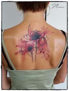 the back of a woman's neck with flowers painted on her upper and lower part