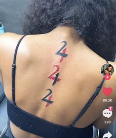 the back of a woman's neck with numbers on it