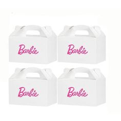 three white boxes with pink lettering on the front and bottom, one is for barbie