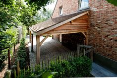 an outside view of a brick building with a wooden roof