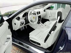 the interior of a car is shown with its door open and steering wheel down,