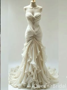 the dress is white and has ruffles on it, as well as a mannequin