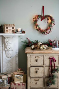 a dresser with christmas decorations and presents on it