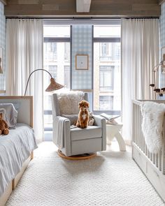 a baby's room with a rocking chair, crib and teddy bear on the floor