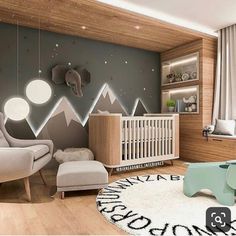 a baby's room with mountains painted on the wall and an elephant rug in the middle