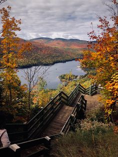 stairs lead down to a lake surrounded by autumn foliage