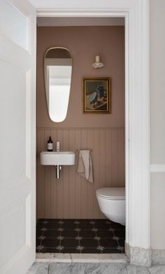 an open door leading to a bathroom with a sink and toilet