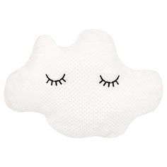 a cloud shaped pillow with eyelashes on it