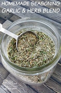 homemade seasoning for garlic and herb blend in a glass jar with a white spoon