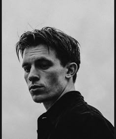 a black and white photo of a man with wet hair looking at the camera,