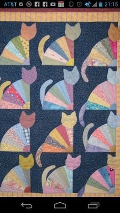 a quilted wall hanging with cats on it