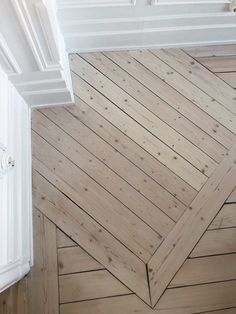 an overhead view of a wooden floor with white trim and wood planks on it