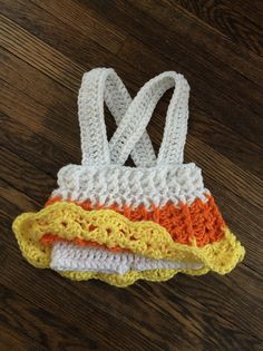 three crocheted hotdogs on top of each other in different colors and sizes