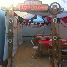 tables and chairs are set up under a marquee