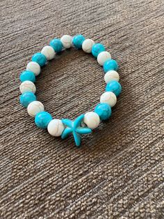 Color - Teal and Cream With Teal Starfish Charm Turquoise Starfish Beaded Bracelets, Ocean-inspired, Ocean-inspired Turquoise Starfish Beaded Bracelets, Handmade Turquoise Starfish Bracelets, Casual Beaded Bracelets With Starfish Charm, Casual Starfish Bracelet For Summer, Casual Star Jewelry For Summer, Casual Star-shaped Summer Jewelry, Casual Summer Star Shaped Jewelry, Handmade Star Bracelets For Beach