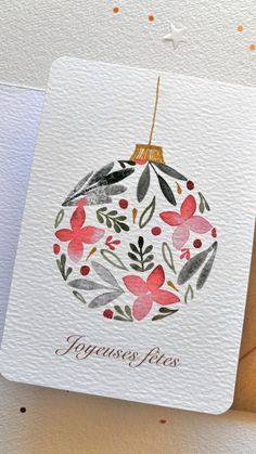 an ornament with flowers and leaves on it is hanging from a string that says happiness fires