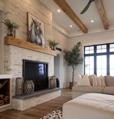 a living room with a couch, coffee table and fireplace