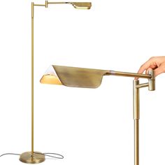 a person is holding the arm of a desk lamp