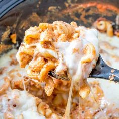 the crock pot million dollar pasta is being held up by a ladle with cheese on it