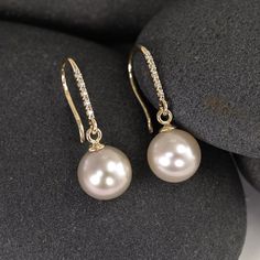 These earrings start with a matched pair of stunning genuine freshwater pearls. They each dangle on custom 14K settings from a line of 5 little pave diamonds, which have been set into solid 14K gold hooks. My favorite thing about these earrings is the way the diamonds and pearls complement and contrast with each other - the large pearls look even more creamy smooth and luminous next to the tiny glittering diamonds. It's a lovely marriage and a perfect balance. The pearls are 9mm genuine, natural Diamond And Pearl Earrings, Bell Earrings, Earrings Pearl Drop, Large Pearl Earrings, Gold Hooks, Peoria Az, Yellow Gold Bangle, Freshwater Pearl Earrings, Diamonds And Pearls