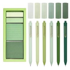 the green pen is next to several different pens