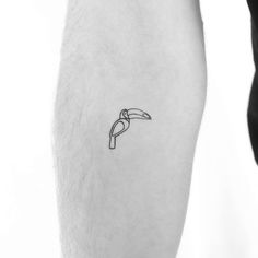 a black and white photo of a person's leg with a small tattoo on it