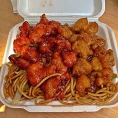 a takeout box filled with chicken and noodles